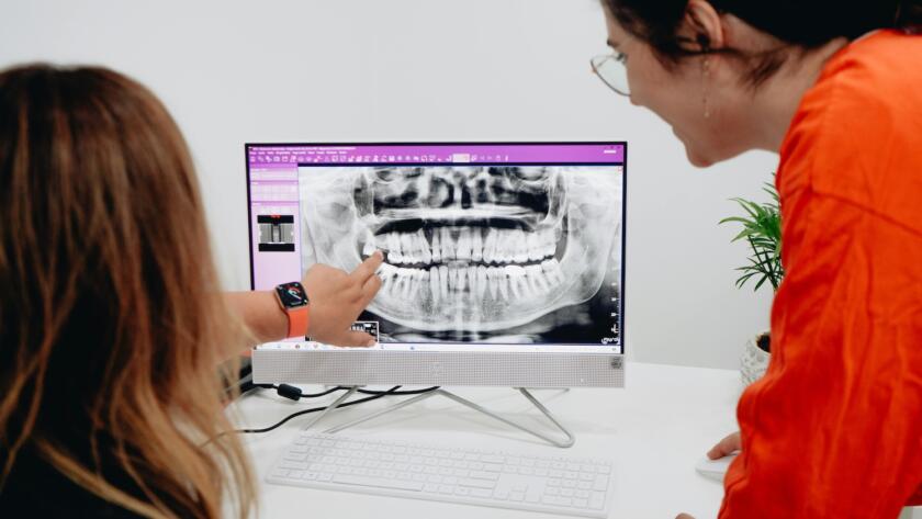 Dentist reviewing dental implant treatment plan with patient
