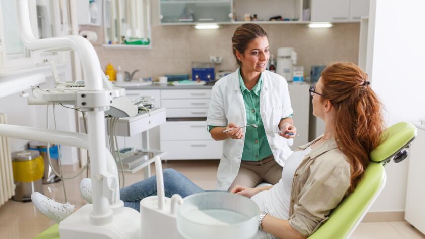 Dentist discussing a dental treatment plan with a patient in a dental office